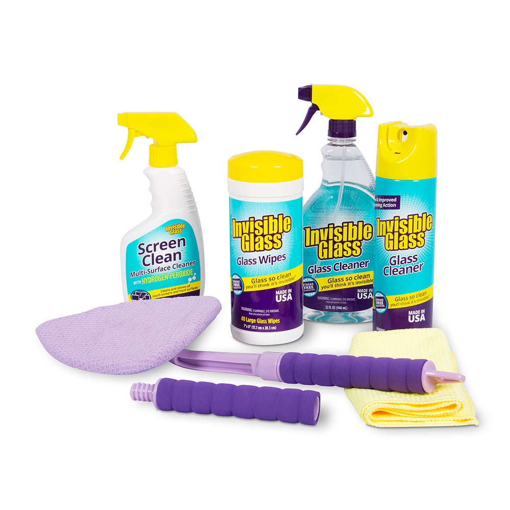 Cleaning products including spray bottles, wipes, and cloths on a white background